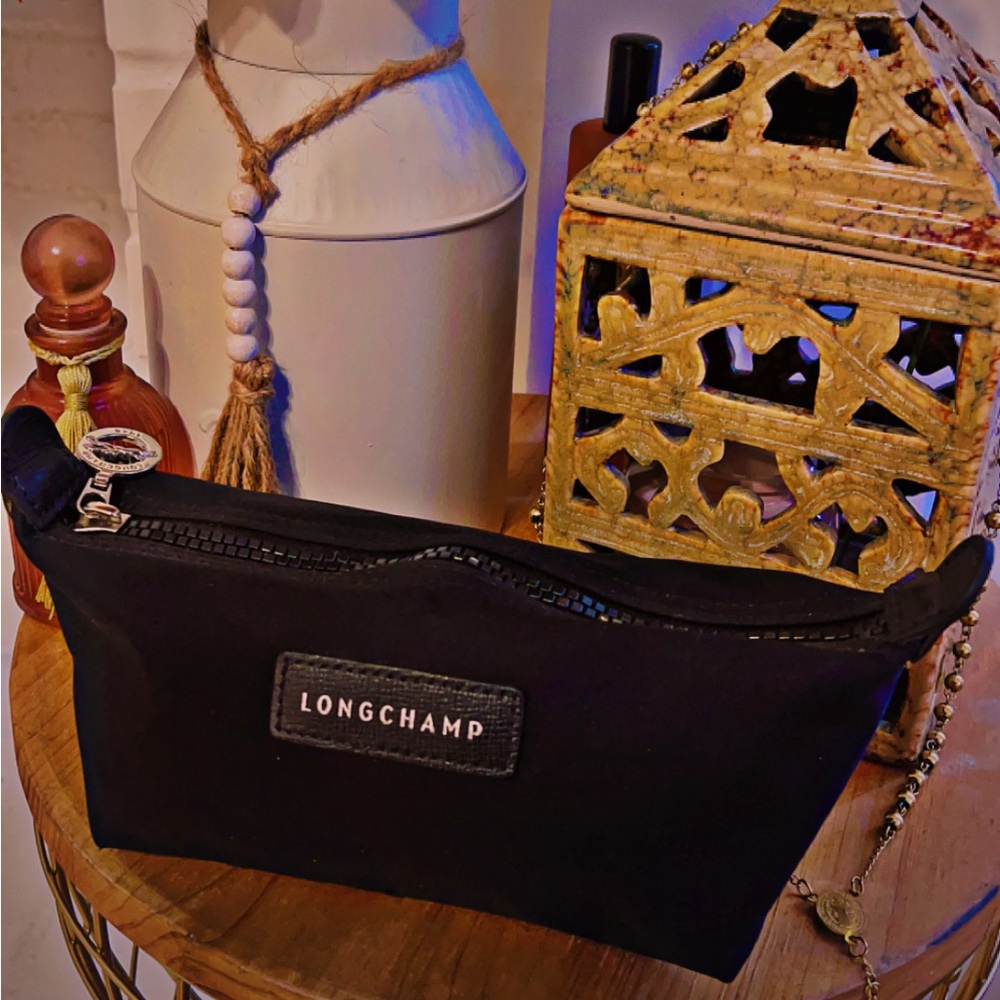Like new Longchamp small toiletry bag w/ silver hardware and black zip closure.